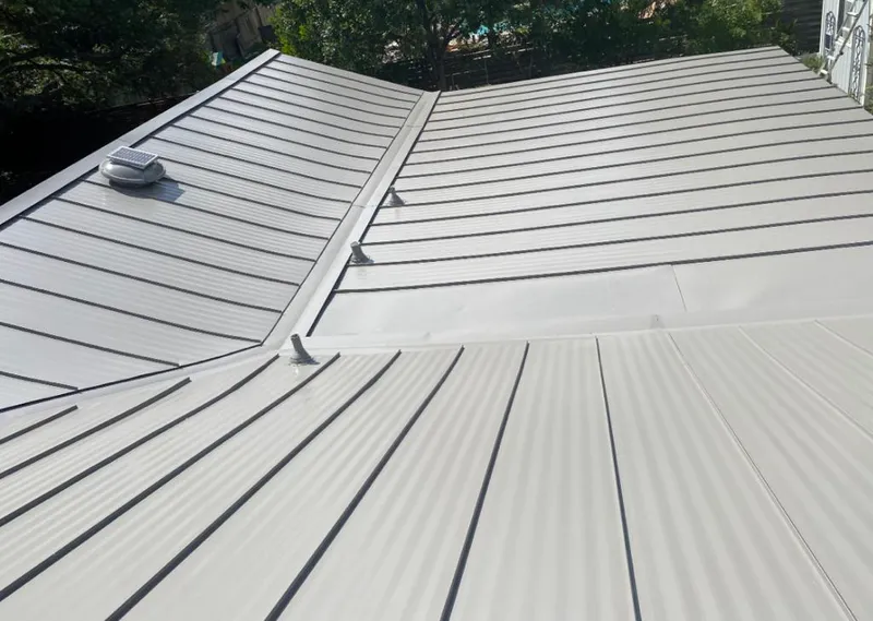 Solar attic fan installed on a metal roof for Roof Ventilation in Mabank